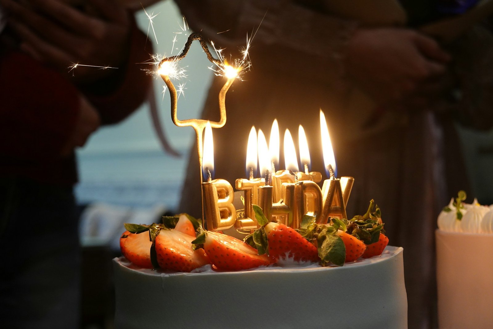 A birthday cake lit with candles